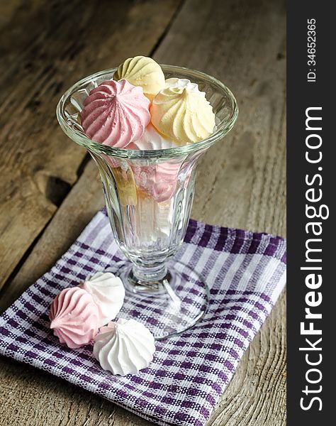 Glass bowl with colorful meringue cookies