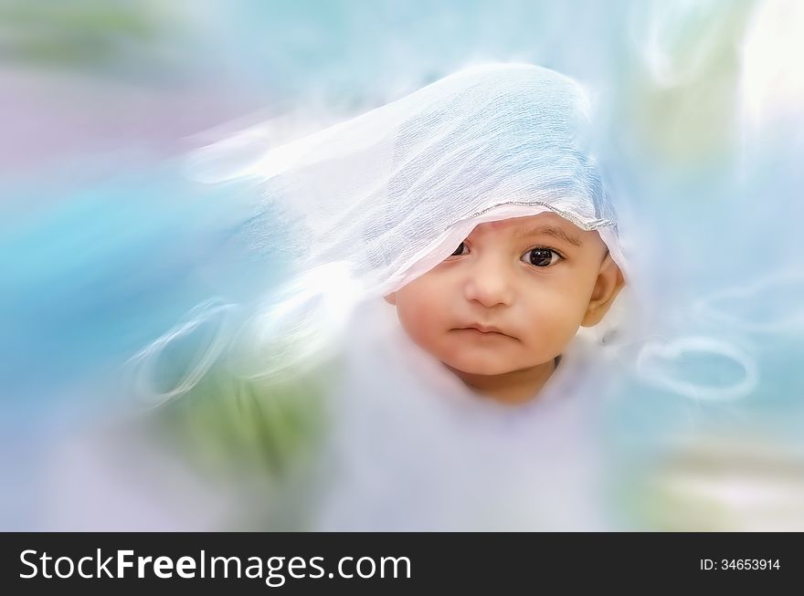 Happy infant baby boy portrait playing with cloth with zoom blur effects. Happy infant baby boy portrait playing with cloth with zoom blur effects