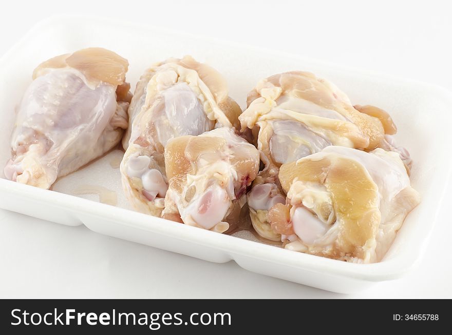 Food fresh chicken in foam isolated on white background. Food fresh chicken in foam isolated on white background