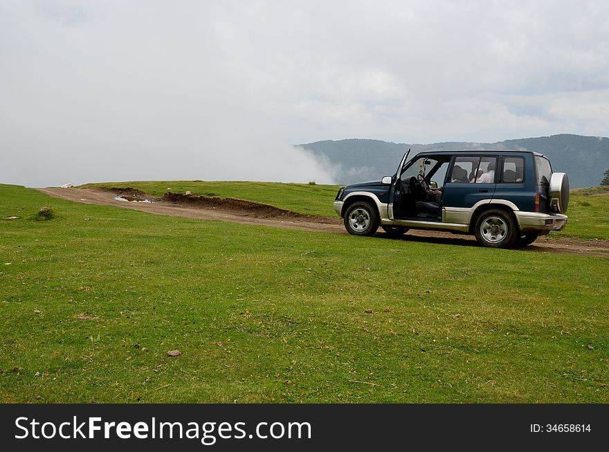 Offroader above the clouds and about to enter into the mist, in Retezat Mountain, Romania. Offroader above the clouds and about to enter into the mist, in Retezat Mountain, Romania.