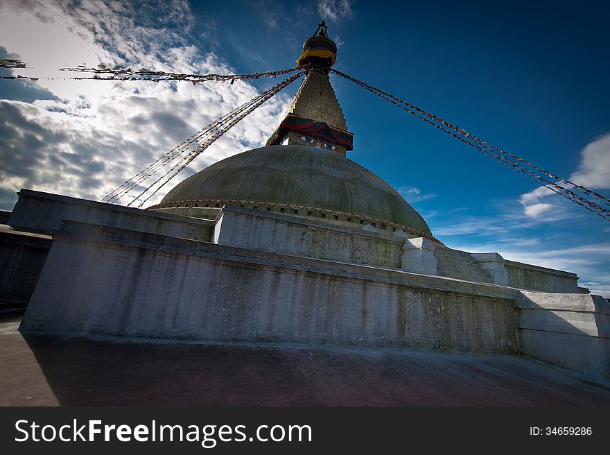 Buddhist Shrine Boudhanath Stupa with pray flags over sunset sky. Nepal, Kathmandu. Buddhist Shrine Boudhanath Stupa with pray flags over sunset sky. Nepal, Kathmandu