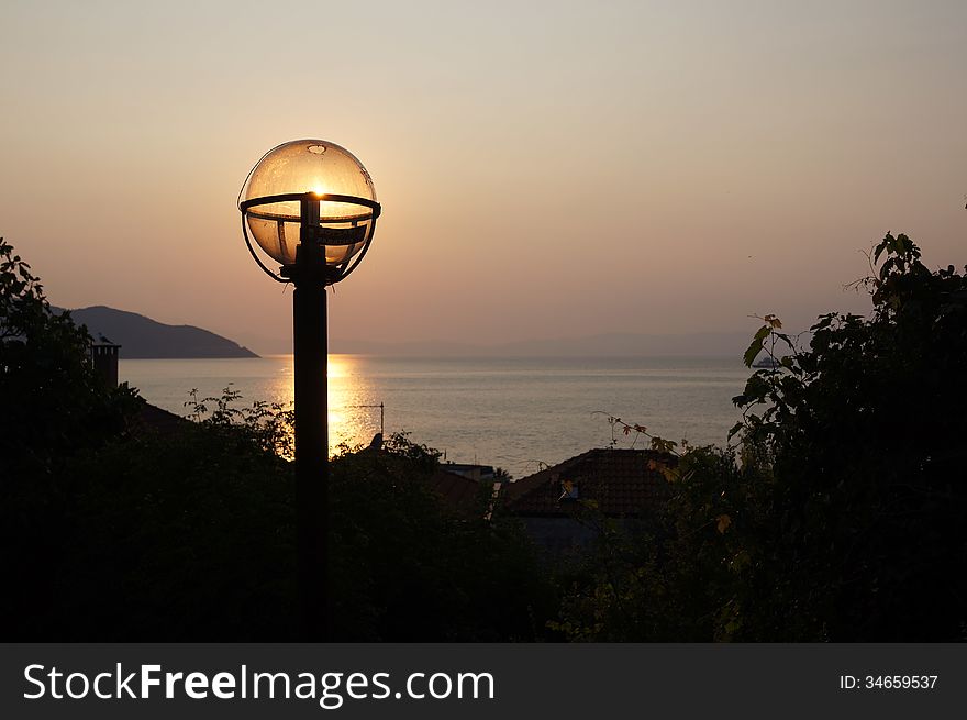 Sunset over sea with light bulb over the sun taken in Thassos island, Greece