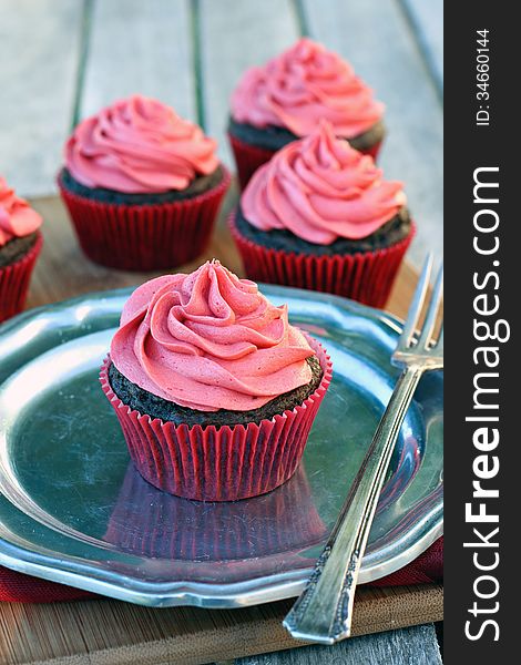 Chocolate cupcakes with cherry frosting. Chocolate cupcakes with cherry frosting.