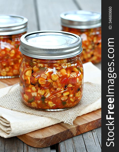 Roasted corn salsa in glass jars.