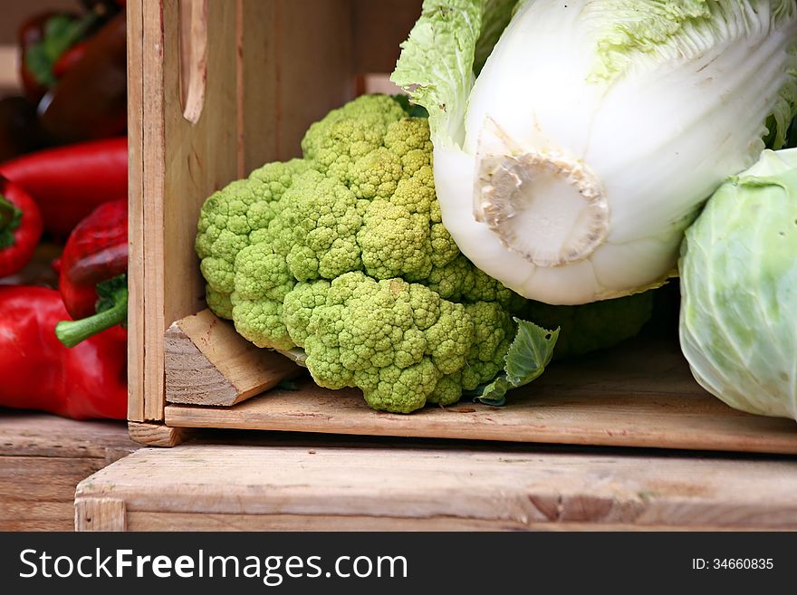 Box of cabbages and green cauliflower. Box of cabbages and green cauliflower.