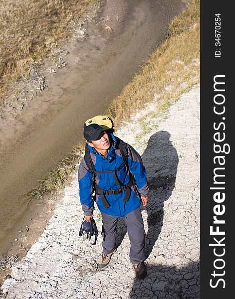 Hiker standing on the river side. high angle shot. Hiker standing on the river side. high angle shot