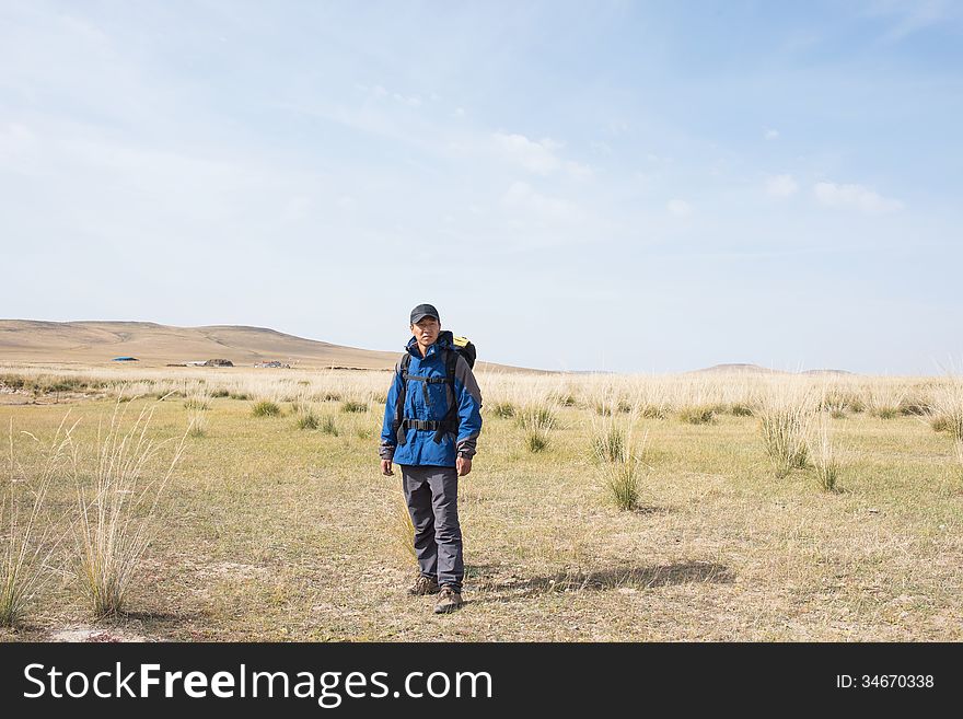 Hikers walking in the autumn meadow. Asian Youth. Hikers walking in the autumn meadow. Asian Youth