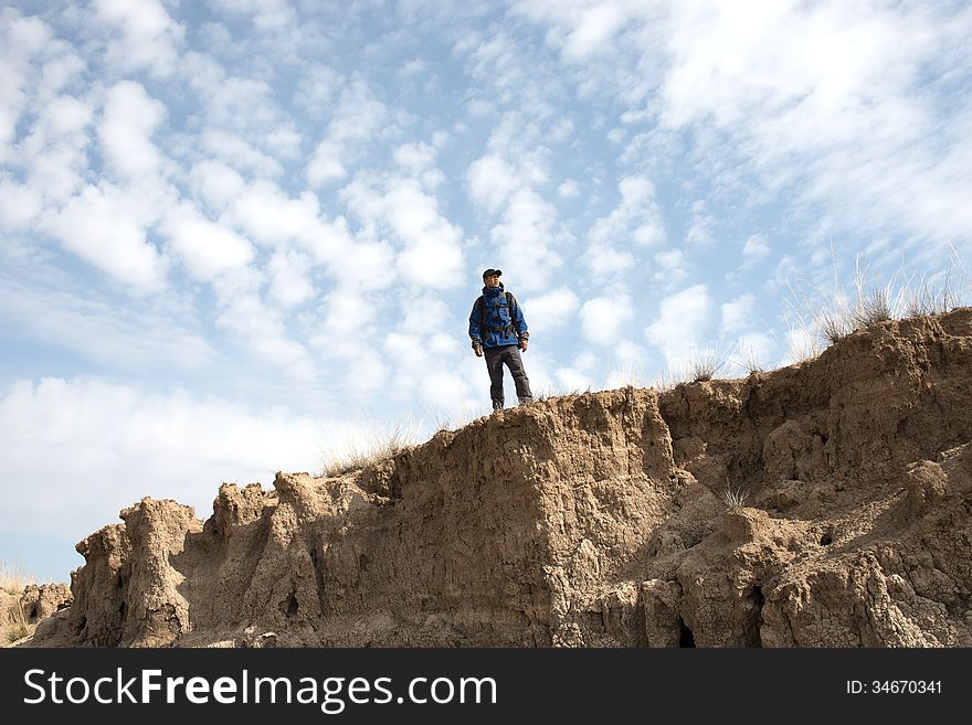 Hiker standing on a cliff overlooking. Asian Youth. Hiker standing on a cliff overlooking. Asian Youth