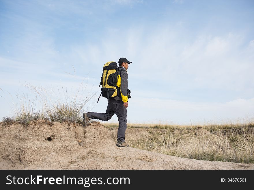 Hikers walking in autumn steep hill. Asian Youth. Hikers walking in autumn steep hill. Asian Youth