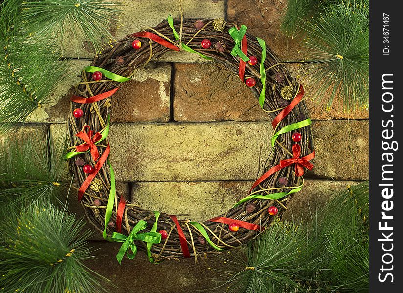 Christmas wreath with conifer branches on stone background