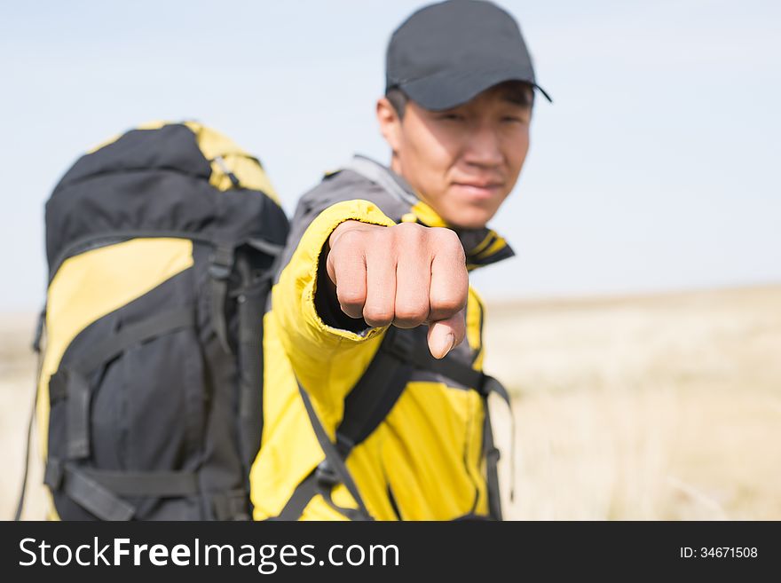 Hikers fist closeup blur background figure. Asian Youth