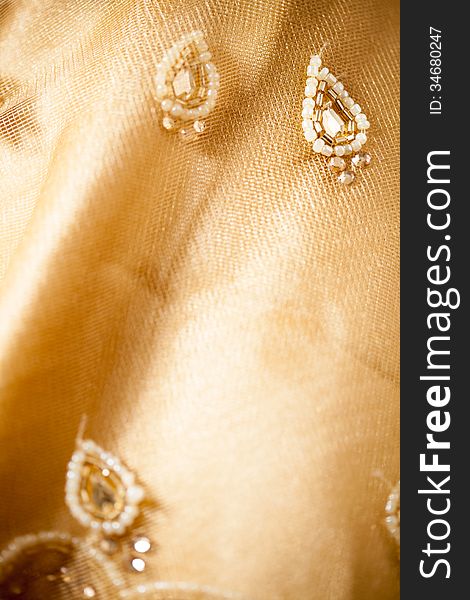 Texture of sari having net and beads, light yellow color. Texture of sari having net and beads, light yellow color