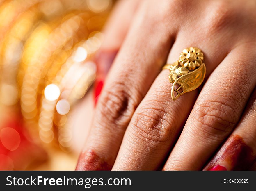 Hand detail of indian bride with decorative bangle and gold ring. Hand detail of indian bride with decorative bangle and gold ring