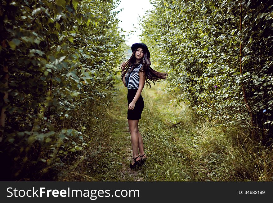 Fashionable Girl Waving Her Hair In Forest