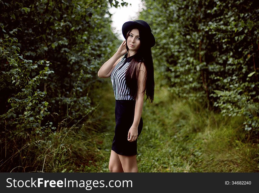 Fashionable Girl Standing In Forest