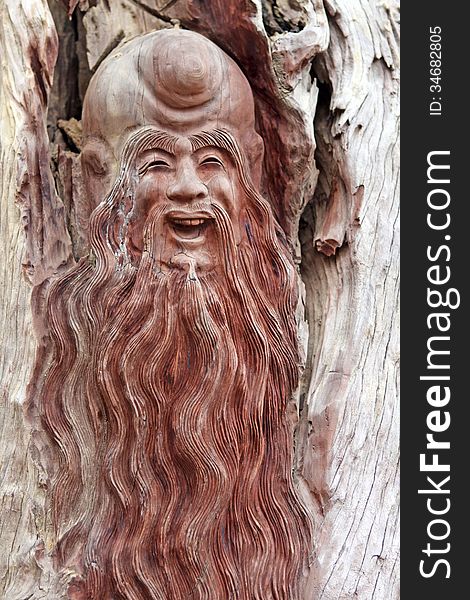 Wooden bas relief of asian long-haired man. Wooden bas relief of asian long-haired man