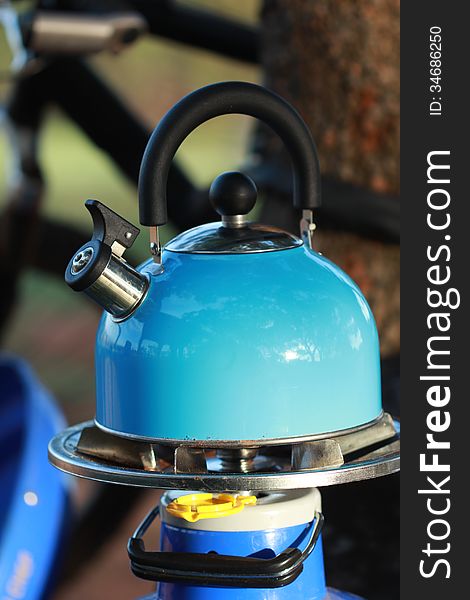 Camping kettle on a gas stove outdoors. Camping kettle on a gas stove outdoors