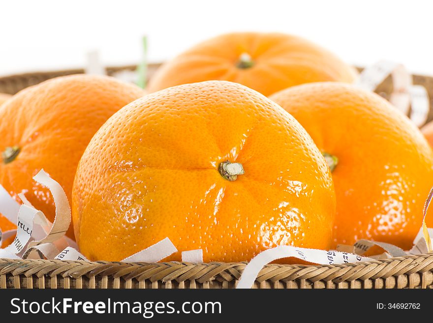 Oranges on shredded paper in basket.isolate on white background. Oranges on shredded paper in basket.isolate on white background.