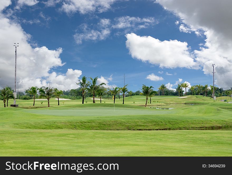 Landscape of a beautiful green golf field with bright blue sky. Landscape of a beautiful green golf field with bright blue sky