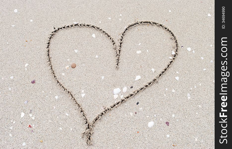 Heart shape drawn  in the sand. Heart shape drawn  in the sand