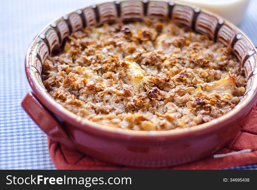 Apple crumble baked in ceramic pot close-up. Apple crumble baked in ceramic pot close-up