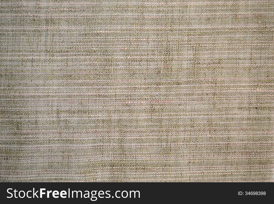 Piece of gray fabric with a coarse weave. Piece of gray fabric with a coarse weave