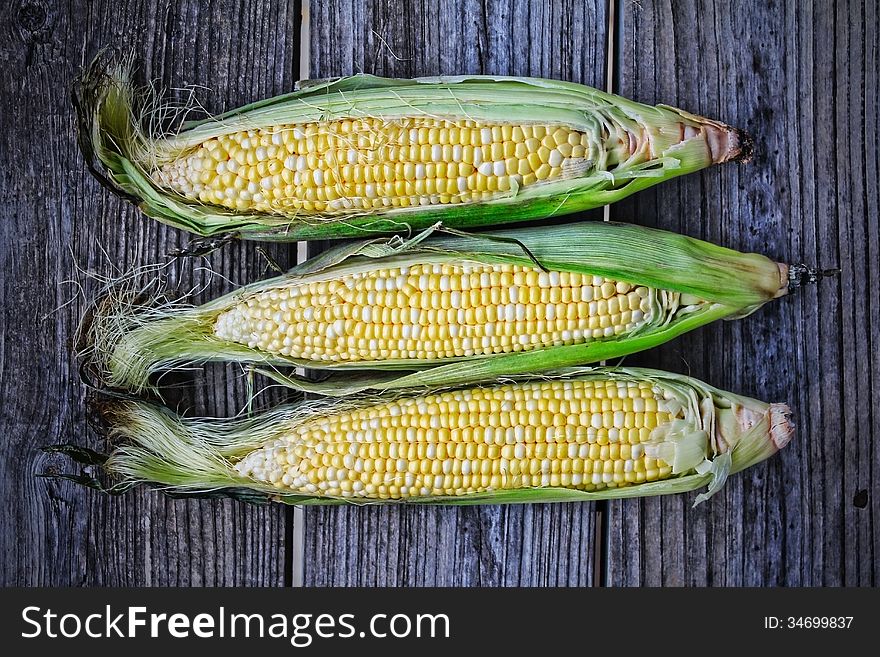 Corn cobs on a wooden table