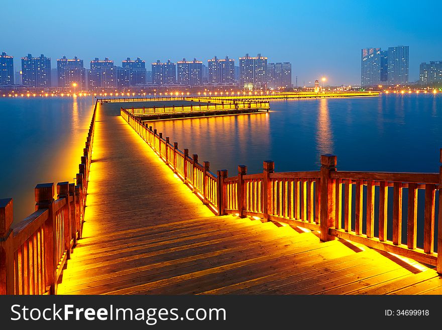 Golden brown wooden footway in night