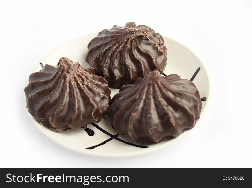 Zephyr in chocolate on white plate