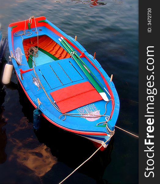 A small fish boat at the port of Isola delle Femmine ( PA Italy) at sunset time