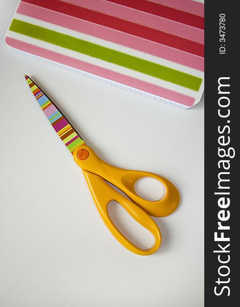Scissors and copybook on the white background