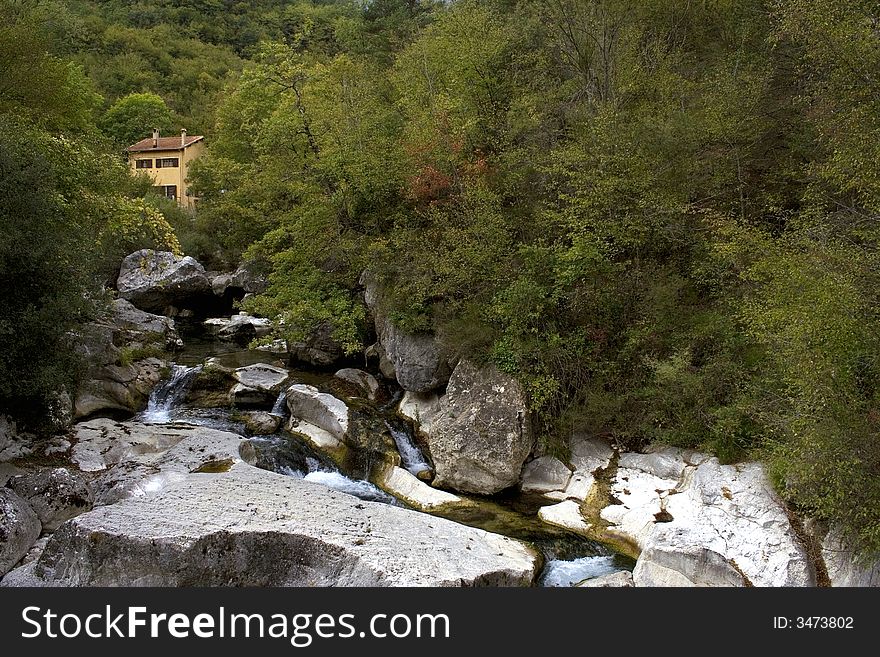 Little house staying in mountains near the waterfall. Little house staying in mountains near the waterfall