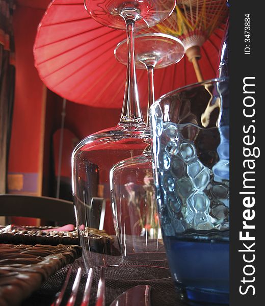 Exotic table set with glasses and red umbrella
