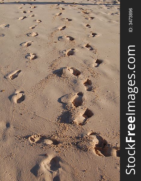 Footsteps on sand beach