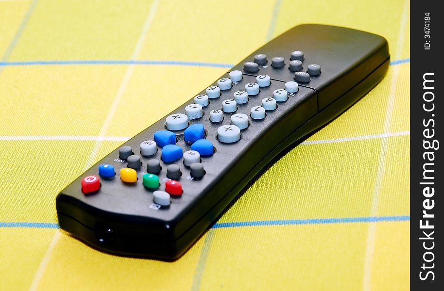 Focus a tv remote on the colours sofa