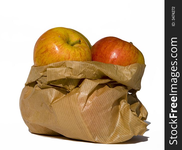 Isolated brown paper bag with apples. White background. Isolated brown paper bag with apples. White background.