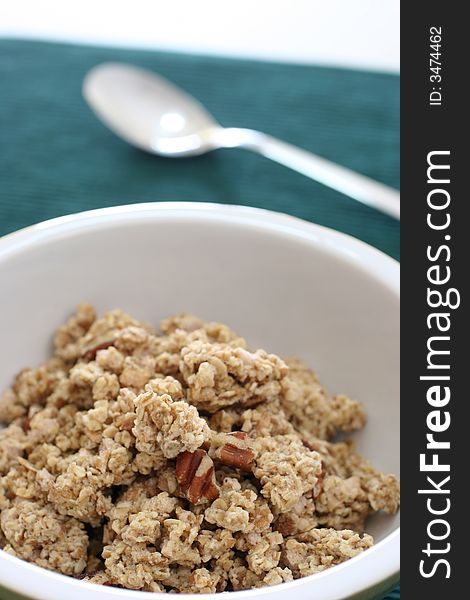 Bowl of crumbly wheat and corn cereal with nutty bits. Bowl of crumbly wheat and corn cereal with nutty bits