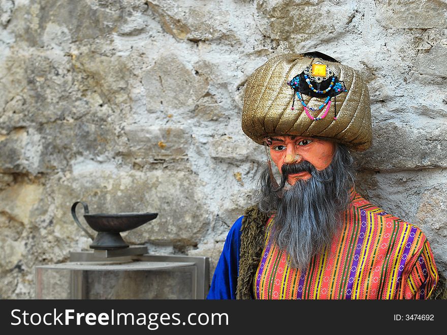 Doll of east wise man on a background wall