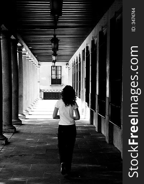 Girl inside an alley, Toledo city, Spain. Grained for more drama.