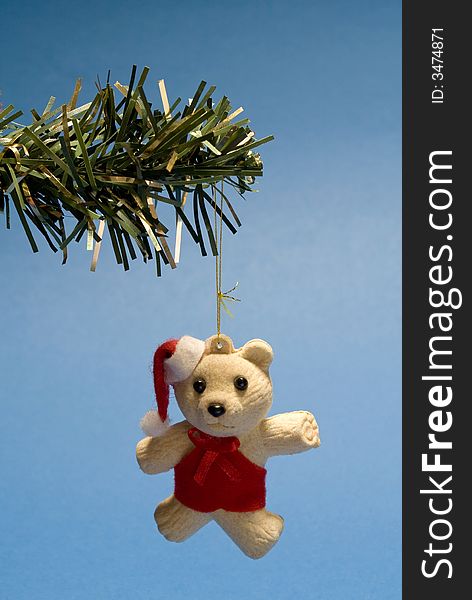 Christmas teddy bear hanging in christmas tree