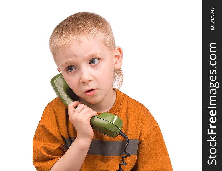 The boy speaks by phone on a white background. The boy speaks by phone on a white background