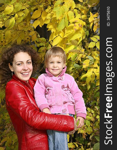 Mother and daughter in the park in autumn. Mother and daughter in the park in autumn