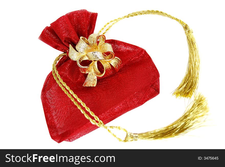Red lace present bag with golden tassels and brooch isolated on white. Red lace present bag with golden tassels and brooch isolated on white