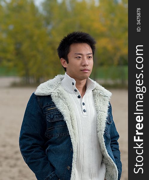 A boy standing on the woodbine beach wearing sports clothing. A boy standing on the woodbine beach wearing sports clothing