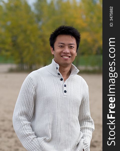 A boy standing on the woodbine beach wearing sports clothing. A boy standing on the woodbine beach wearing sports clothing