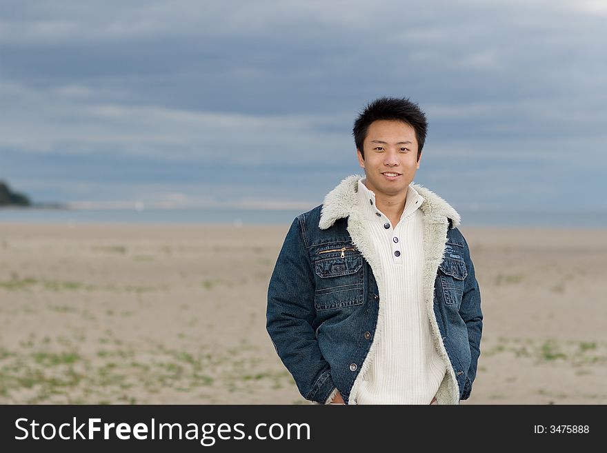 A boy standing on the woodbine beach wearing sports clothing. A boy standing on the woodbine beach wearing sports clothing