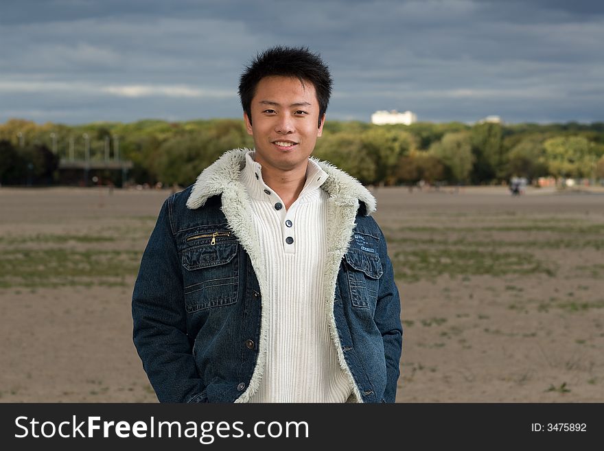 A boy standing on the woodbine beach wearing sports clothing. A boy standing on the woodbine beach wearing sports clothing