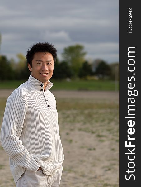 A boy standing on the woodbine beach wearing sports clothing. A boy standing on the woodbine beach wearing sports clothing