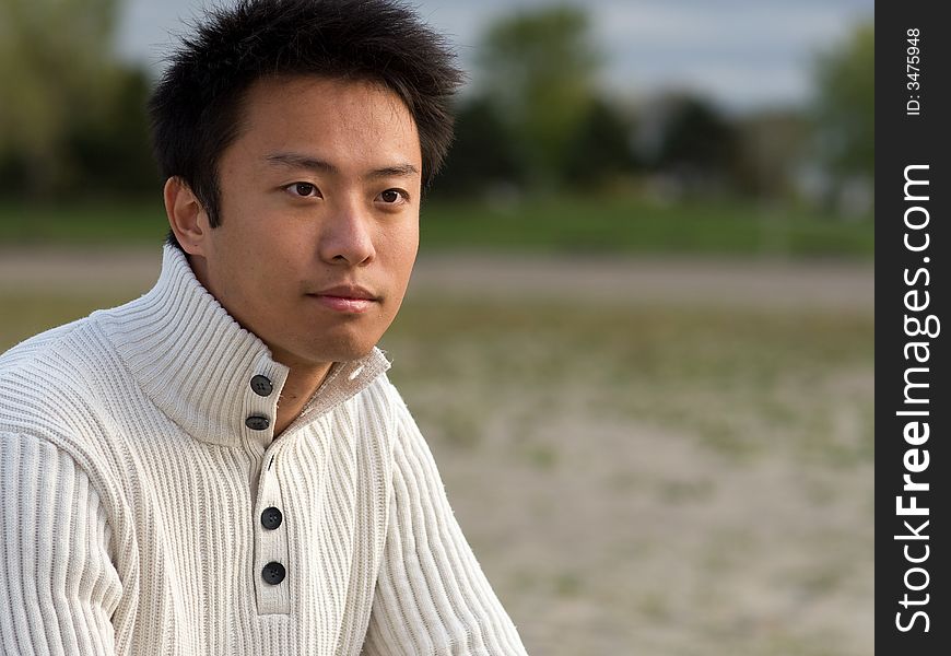 A boy standing on the woodbine beach wearing sports clothing. A boy standing on the woodbine beach wearing sports clothing