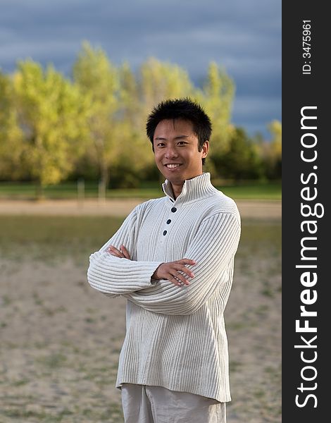 A boy standing on the woodbine beach wearing sports clothing. A boy standing on the woodbine beach wearing sports clothing